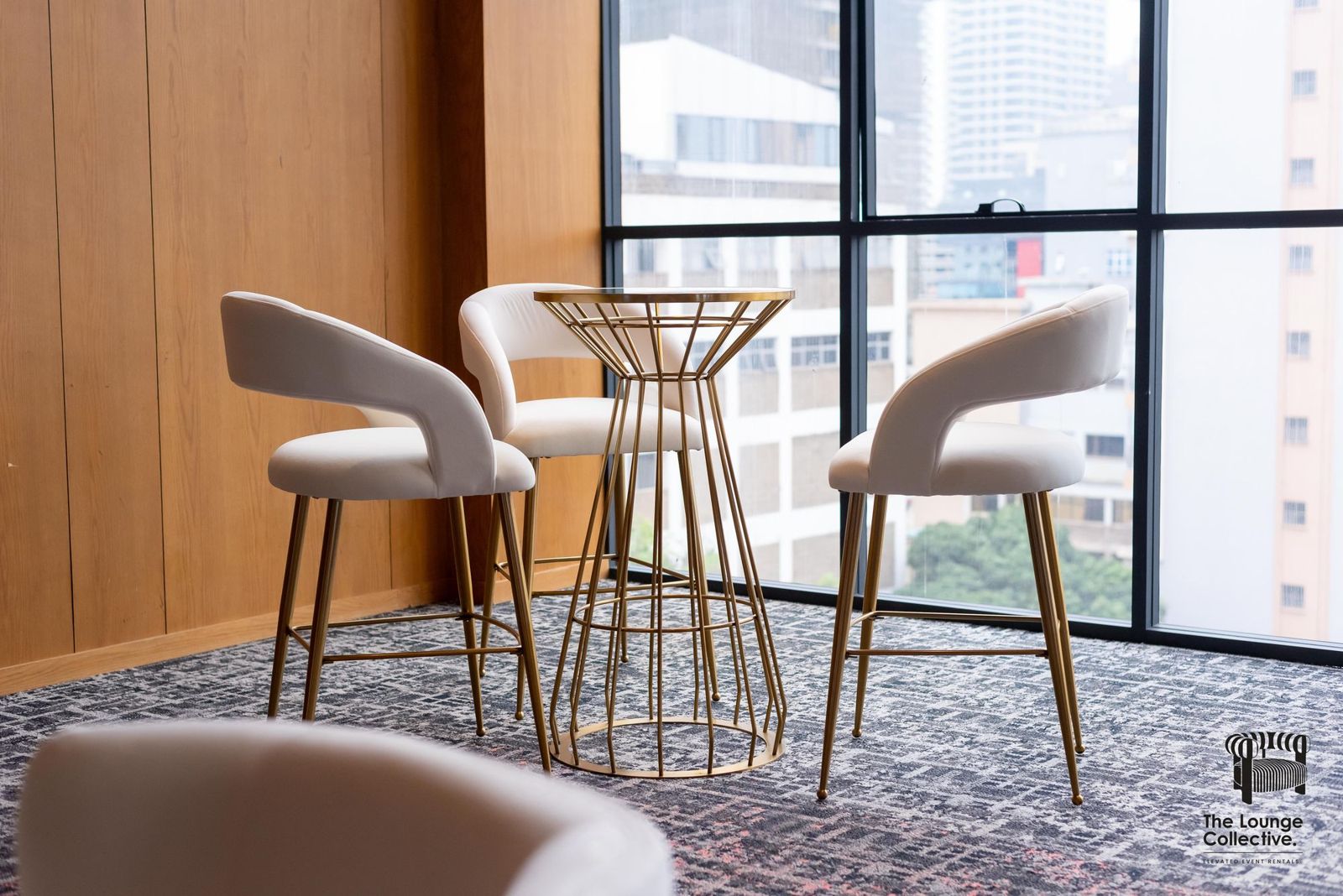 Brushed Gold cocktail stools and a gold high table by the window
